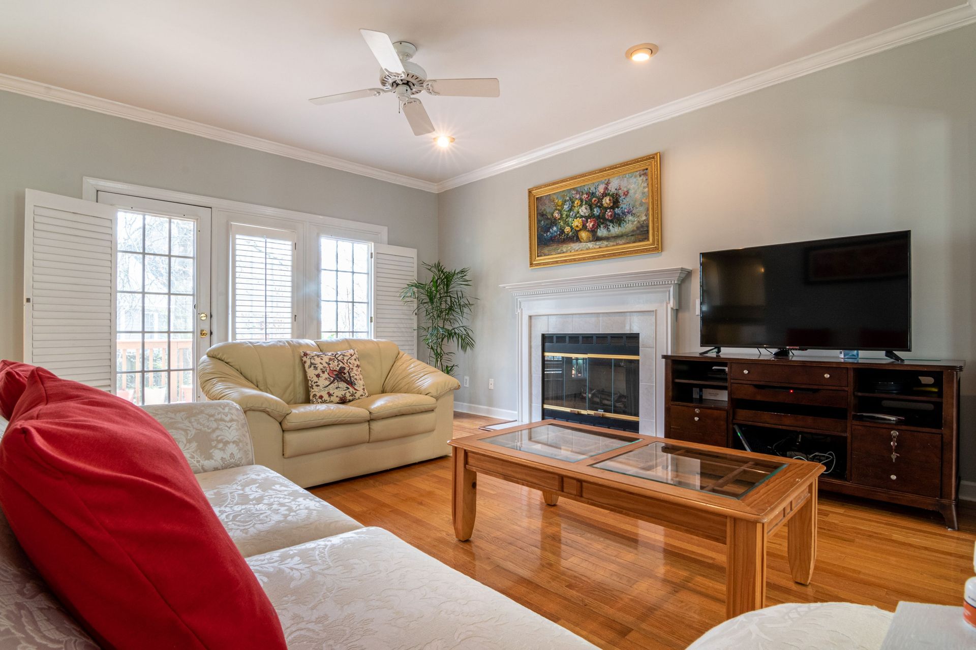 A contemporary living room featuring a fireplace, TV, and stylish furniture in a cozy residential setting.